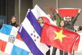 students at international education week parade holding flags