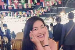 Student with her hands on her face in a restaurant