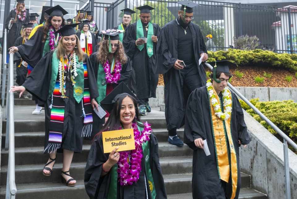 international studies graduate walking down stairs